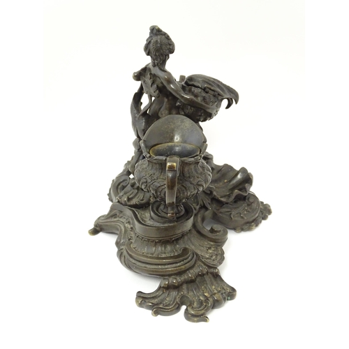 1295 - A cast desk standish in the Renaissance style with central merman flanked by two inkwells, and shell... 