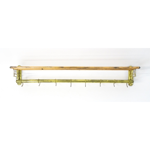 1329 - An Arts & Crafts style copper and brass  hat / coat rack with brass pierced brackets and eight hooks... 