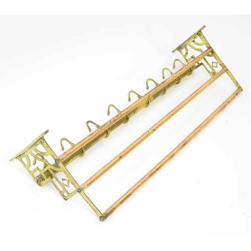 1329 - An Arts & Crafts style copper and brass  hat / coat rack with brass pierced brackets and eight hooks... 