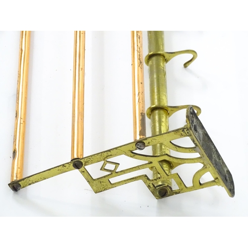 1329 - An Arts & Crafts style copper and brass  hat / coat rack with brass pierced brackets and eight hooks... 