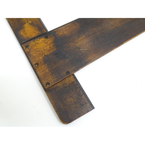 1336 - Two artist's tools comprising an early 20thC wooden T-square by Winsor & Newton Ltd., and a George R... 