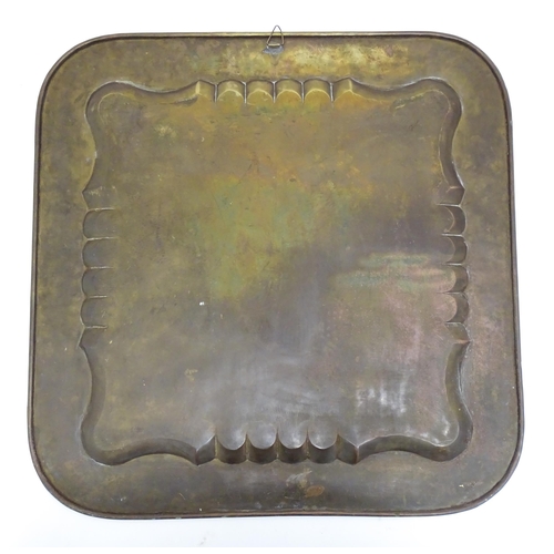 1340 - A Persian brass tray of squared form with engraved decoration depicting a garden landscape with a ki... 