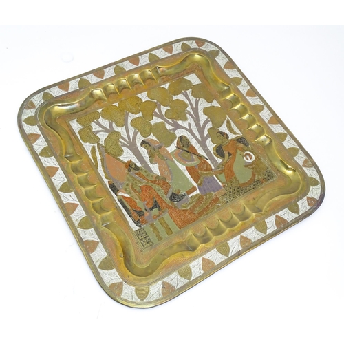 1340 - A Persian brass tray of squared form with engraved decoration depicting a garden landscape with a ki... 