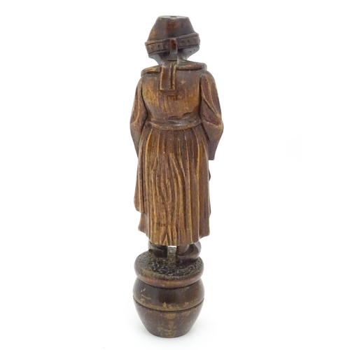 1349 - A Continental carved wooden figure of a Dutch lady in traditional costume and wearing clogs. The who... 