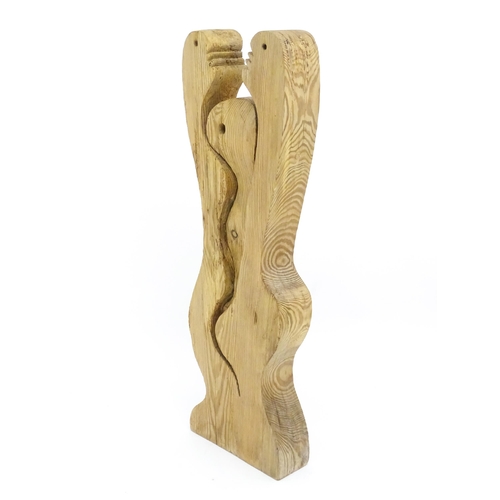 1353 - A carved wooden abstract sculpture formed as stylised interpretive man woman and baby. Approx 28