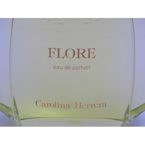 1370 - A large / oversized shop display advertising perfume bottle for Flore by Carolina Herrera. Approx. 1... 