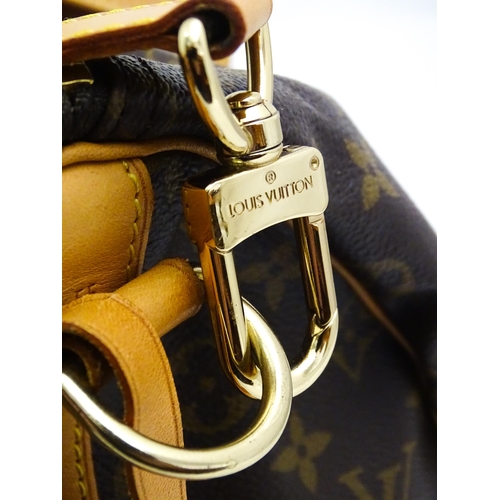 1399 - A Louis Vuitton Keepall 55 bag with shoulder strap and luggage label. Measures 21 3/4 x 12 1/4 x 9 1... 