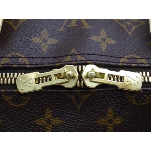 1399 - A Louis Vuitton Keepall 55 bag with shoulder strap and luggage label. Measures 21 3/4 x 12 1/4 x 9 1... 