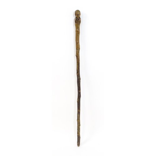 1410 - Stick / Cane : A waking stick with naïve folk art style carved handle formed as the head of the Scot... 