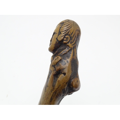 1410 - Stick / Cane : A waking stick with naïve folk art style carved handle formed as the head of the Scot... 