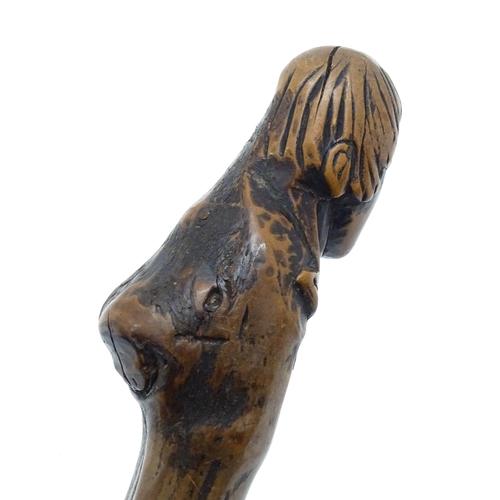 1410 - Stick / Cane : A waking stick with naïve folk art style carved handle formed as the head of the Scot... 