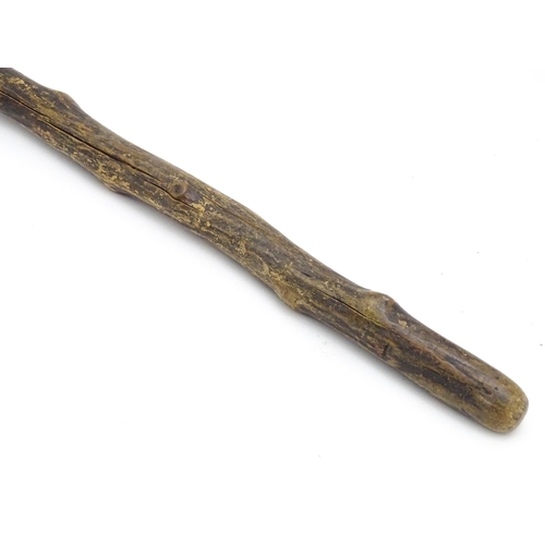 1410 - Stick / Cane : A waking stick with naïve folk art style carved handle formed as the head of the Scot... 