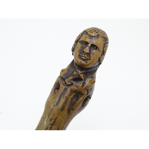 1410 - Stick / Cane : A waking stick with naïve folk art style carved handle formed as the head of the Scot... 