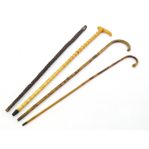 1411 - Sticks / Canes : Four assorted walking stick / canes to include an example with carved Oriental deco... 