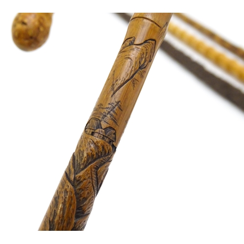 1411 - Sticks / Canes : Four assorted walking stick / canes to include an example with carved Oriental deco... 