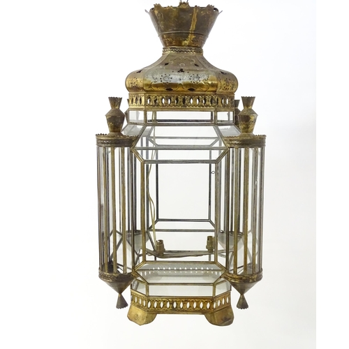 1553 - A glass panelled pendant light of lantern form with pierced detail to the metal work, in the Morocca... 