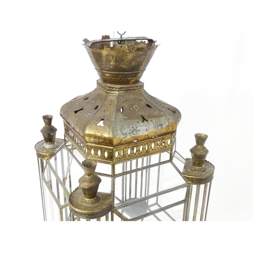 1553 - A glass panelled pendant light of lantern form with pierced detail to the metal work, in the Morocca... 