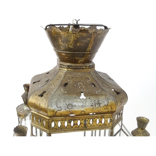 1553 - A glass panelled pendant light of lantern form with pierced detail to the metal work, in the Morocca... 