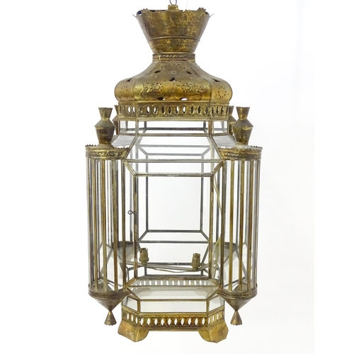 1553 - A glass panelled pendant light of lantern form with pierced detail to the metal work, in the Morocca... 