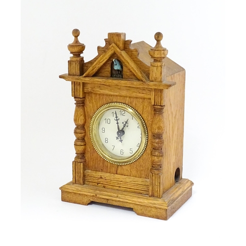 1547 - An oak mantel clock with cuckoo to top. Approx 9 1/2