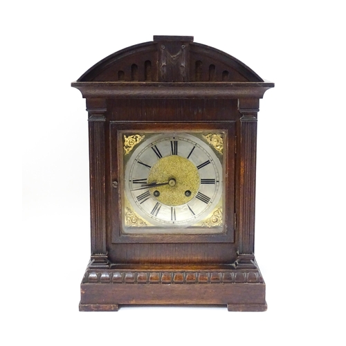 1547A - A continental oak cased mantle clock with silvered chapter ring , the 8-day movement striking on a g... 