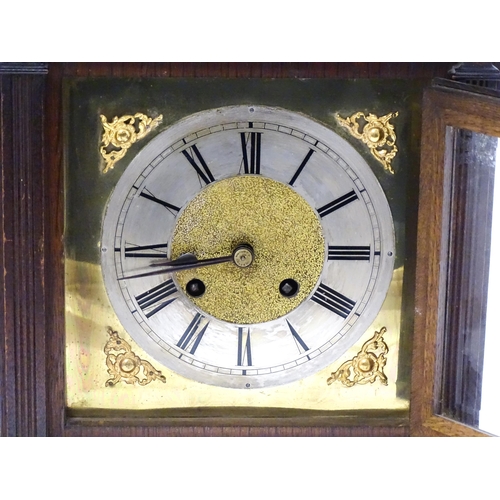 1547A - A continental oak cased mantle clock with silvered chapter ring , the 8-day movement striking on a g... 