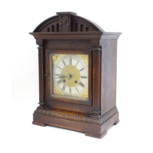 1547A - A continental oak cased mantle clock with silvered chapter ring , the 8-day movement striking on a g... 