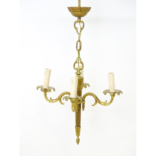 1561 - A four branch gilt metal pendant electrolier / light with acanthus detail. Approx. 25