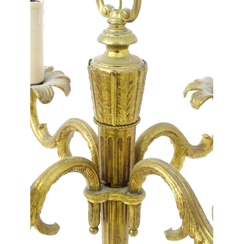 1561 - A four branch gilt metal pendant electrolier / light with acanthus detail. Approx. 25