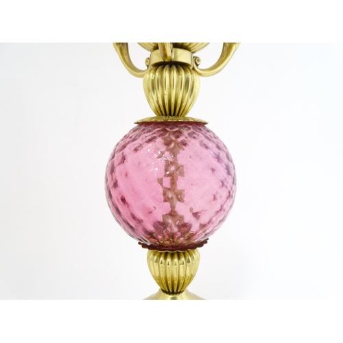 1572 - A mid 20thC table lamp formed as an oil lamp with cranberry glass detail. Approx 19 1/2