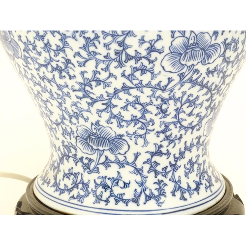 1575 - A table lamp of Chinese baluster vase an cover form with blue floral and foliate detail. Approx 20