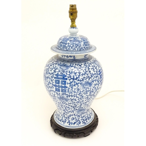 1575 - A table lamp of Chinese baluster vase an cover form with blue floral and foliate detail. Approx 20