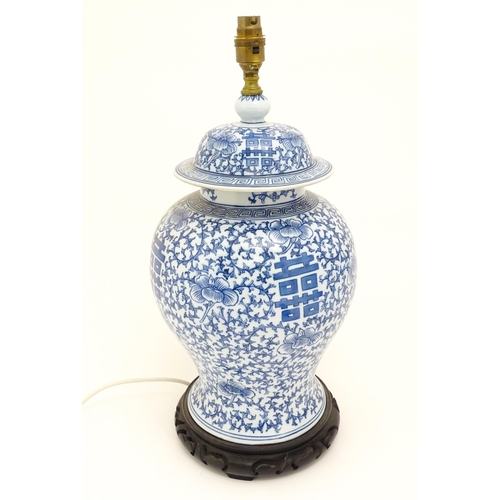 1575 - A table lamp of Chinese baluster vase an cover form with blue floral and foliate detail. Approx 20