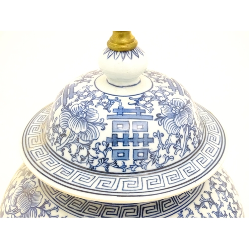 1575 - A table lamp of Chinese baluster vase an cover form with blue floral and foliate detail. Approx 20