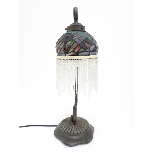 1579 - A Tiffany style table lamp with dragon fly detail to shade. The whole approx 19