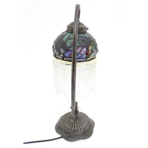 1579 - A Tiffany style table lamp with dragon fly detail to shade. The whole approx 19