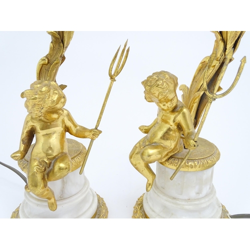 1581 - A pair of table amps with cast and gilded cherub detail. Approx 19