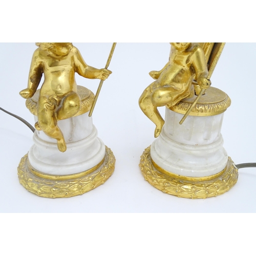 1581 - A pair of table amps with cast and gilded cherub detail. Approx 19