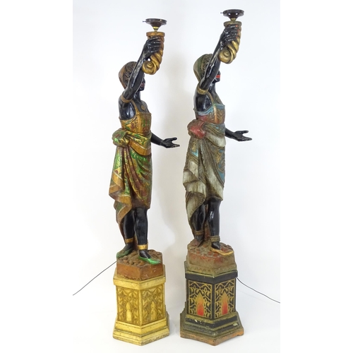 1589 - Two mid 20thC blackamoor lamps, the lamps having a polychrome figural top grasping a torchiere, the ... 