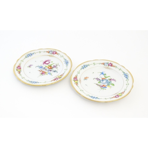 57 - Two Dresden plates decorated with flowers and foliage with gilt rims. Marked under. Approx. 7 3/4
