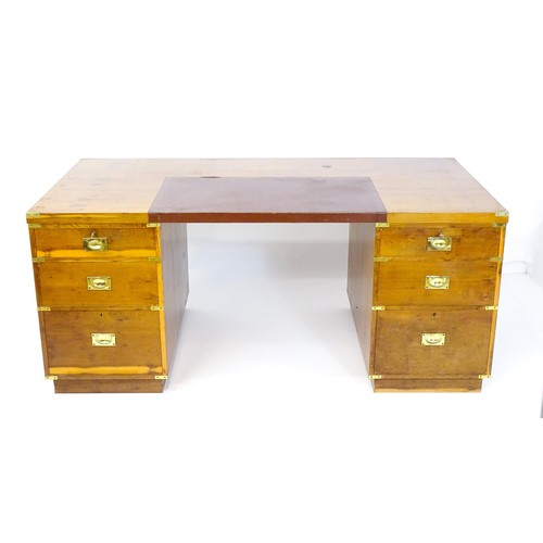 1667 - A campaign style yew wood veneered partners desk, with brass mounts to the corners of the desk top a... 