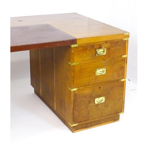 1667 - A campaign style yew wood veneered partners desk, with brass mounts to the corners of the desk top a... 