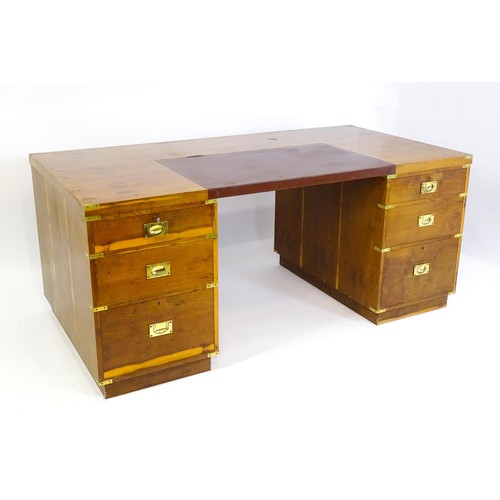 1667 - A campaign style yew wood veneered partners desk, with brass mounts to the corners of the desk top a... 