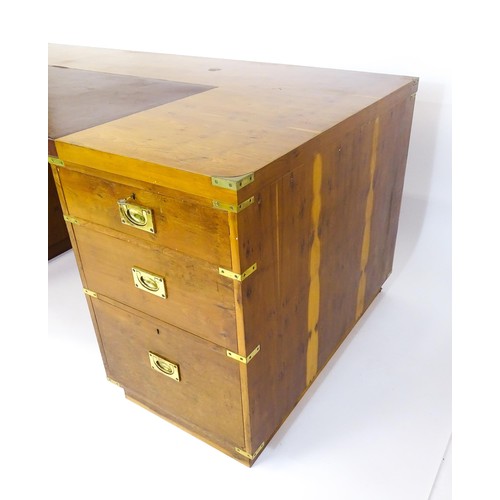 1667 - A campaign style yew wood veneered partners desk, with brass mounts to the corners of the desk top a... 