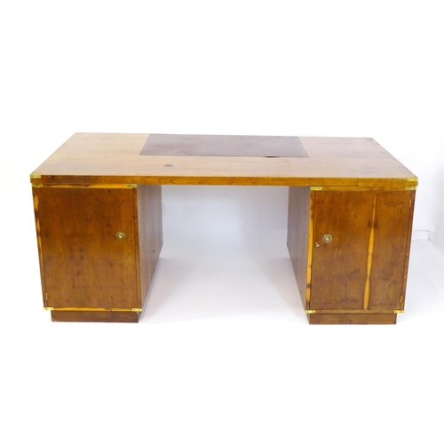 1667 - A campaign style yew wood veneered partners desk, with brass mounts to the corners of the desk top a... 