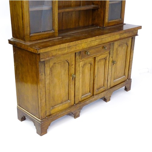 1728 - An early 20thC oak and burr walnut veneered dresser with a moulded cornice over two glazed cupboards... 