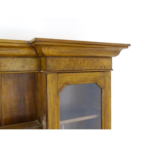 1728 - An early 20thC oak and burr walnut veneered dresser with a moulded cornice over two glazed cupboards... 