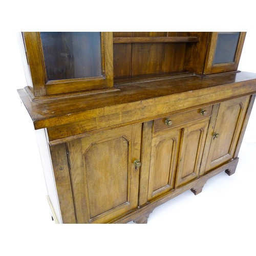 1728 - An early 20thC oak and burr walnut veneered dresser with a moulded cornice over two glazed cupboards... 