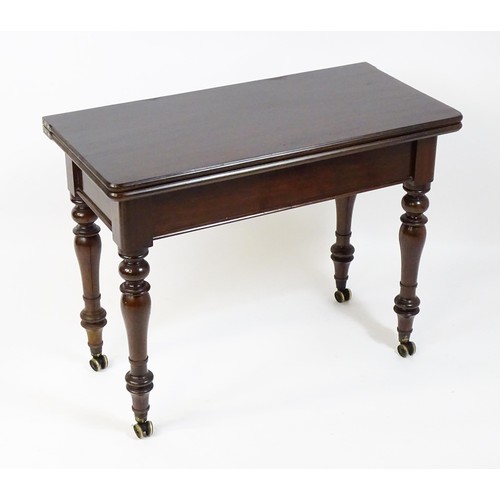 1623 - A 19thC mahogany tea table, with a hinged top above four turned tapering legs terminating in unusual... 