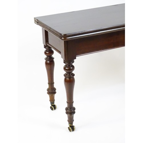 1623 - A 19thC mahogany tea table, with a hinged top above four turned tapering legs terminating in unusual... 